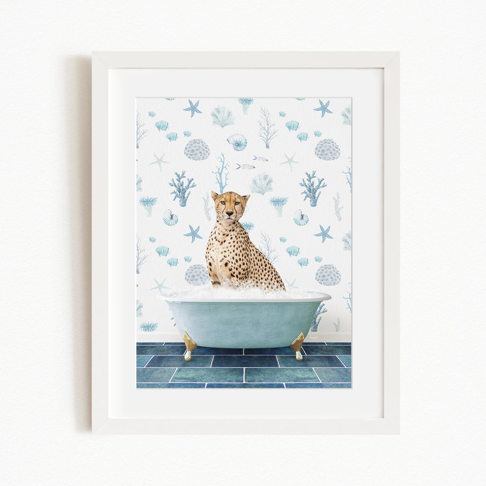 A cheetah sitting in a bathtub filled with bubbles, surrounded by a blue and white ocean-themed wallpaper.