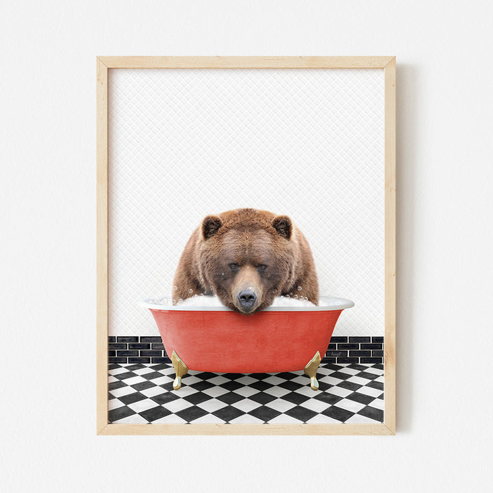 a brown bear sitting in a red bath tub