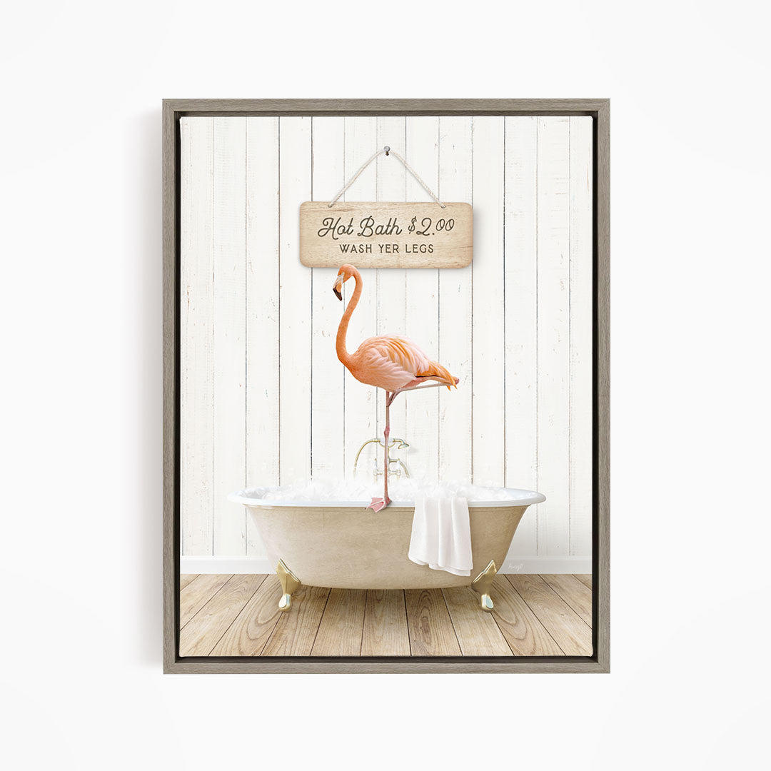 A framed image of a pink flamingo standing on a white bathtub, with a sign above it that reads "Hot Bath $2.00 WASH YOUR LEGS".