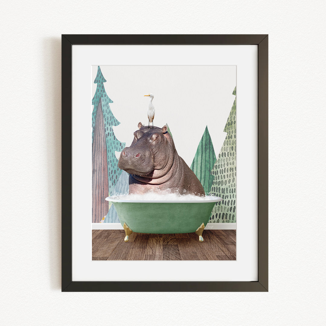 A framed image depicting a hippopotamus sitting in a green bathtub, with a bird perched on its head.