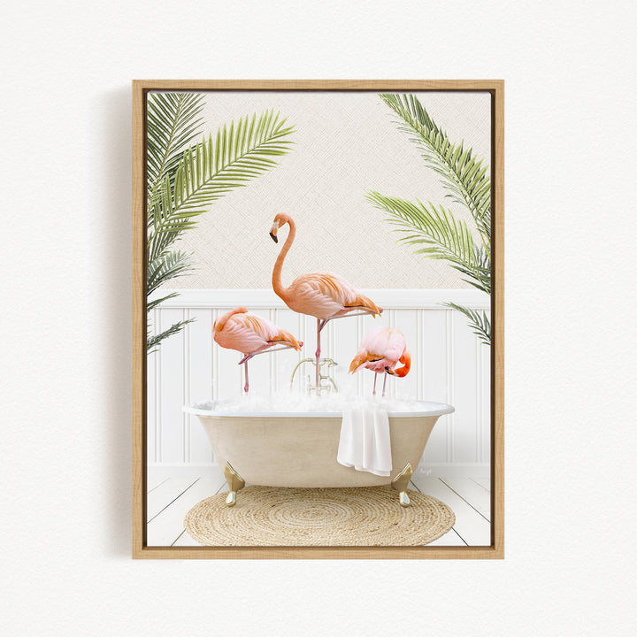 A framed image depicting three flamingos standing in a bathtub, surrounded by palm leaves.