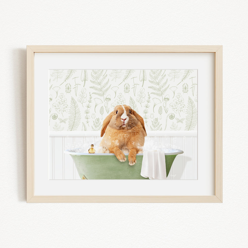 A brown rabbit sitting in a green bathtub, surrounded by a white towel and a yellow rubber duck.