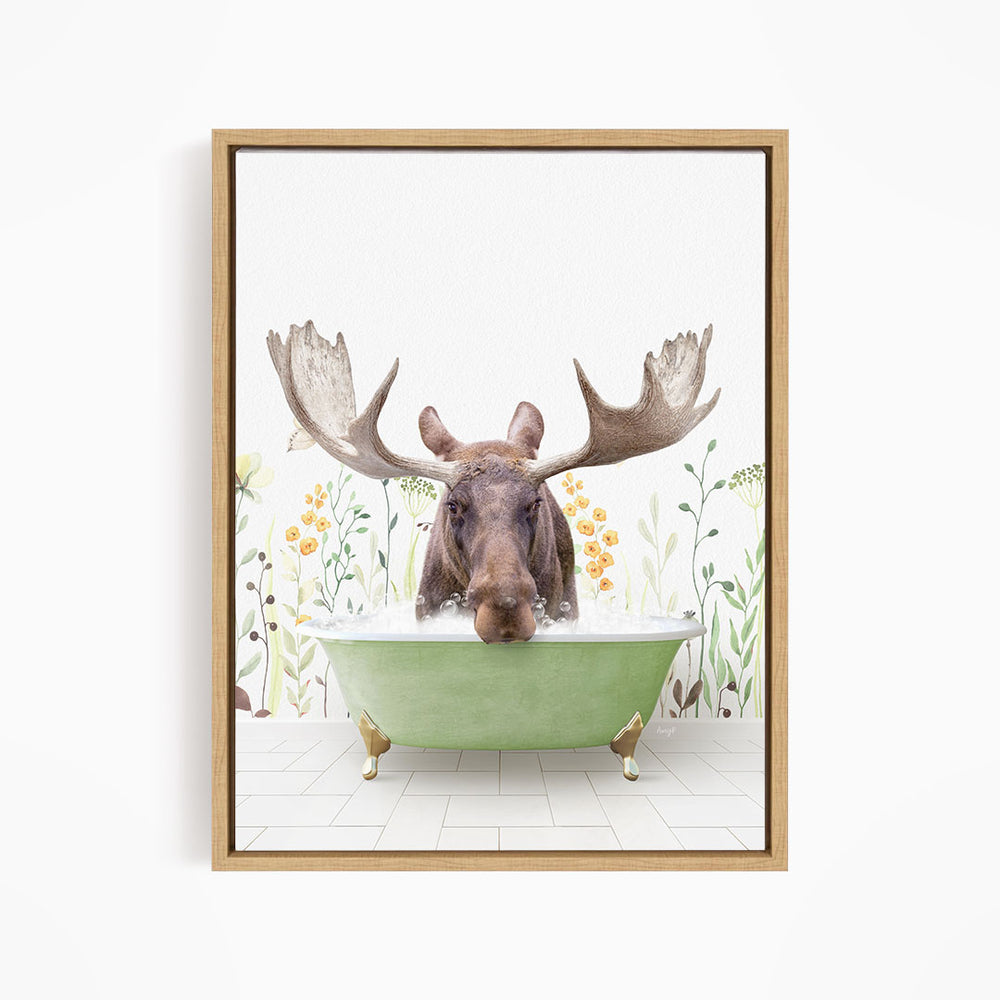 A moose with large antlers is sitting in a green bathtub, surrounded by flowers and plants.
