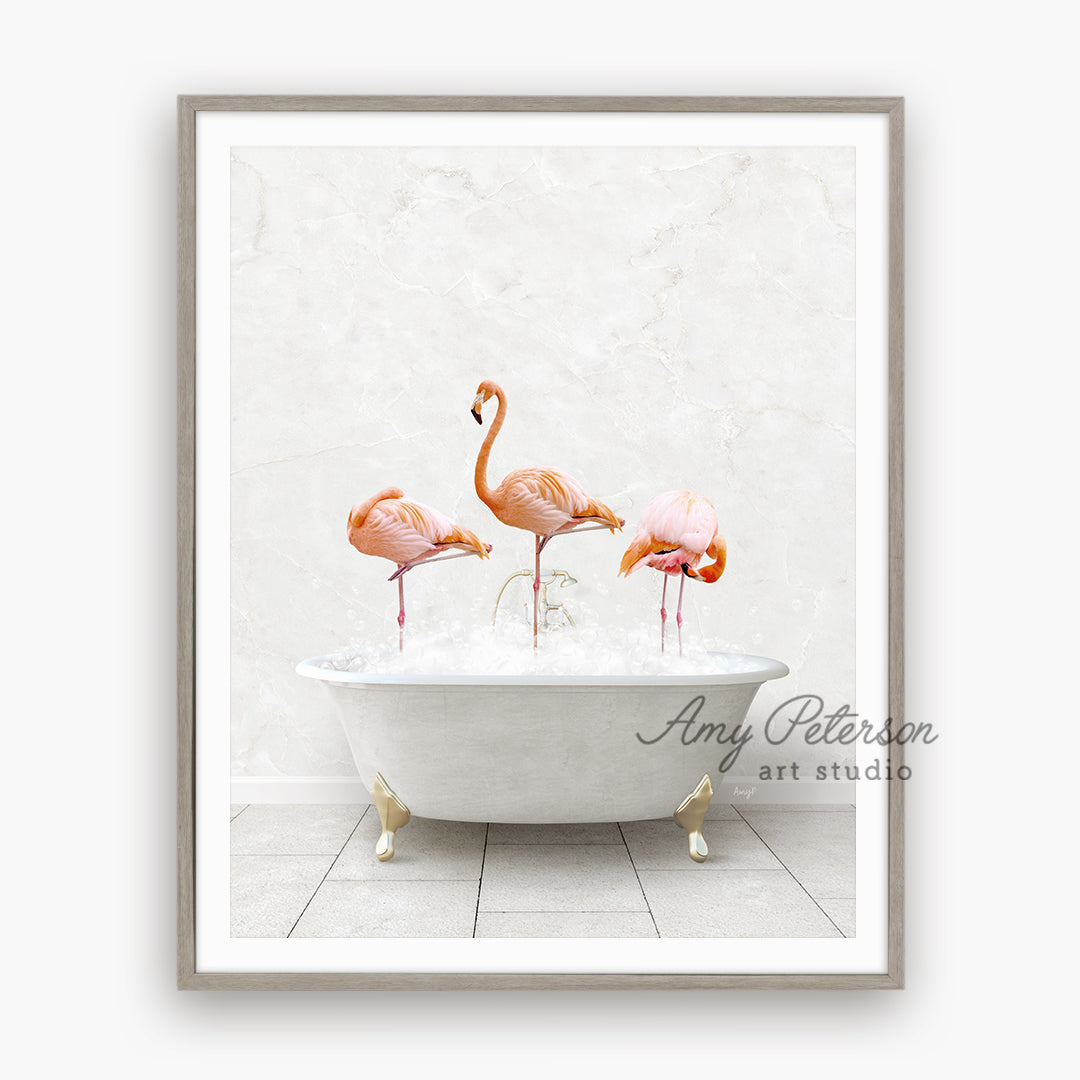 three pink flamingos in a bathtub with bubbles