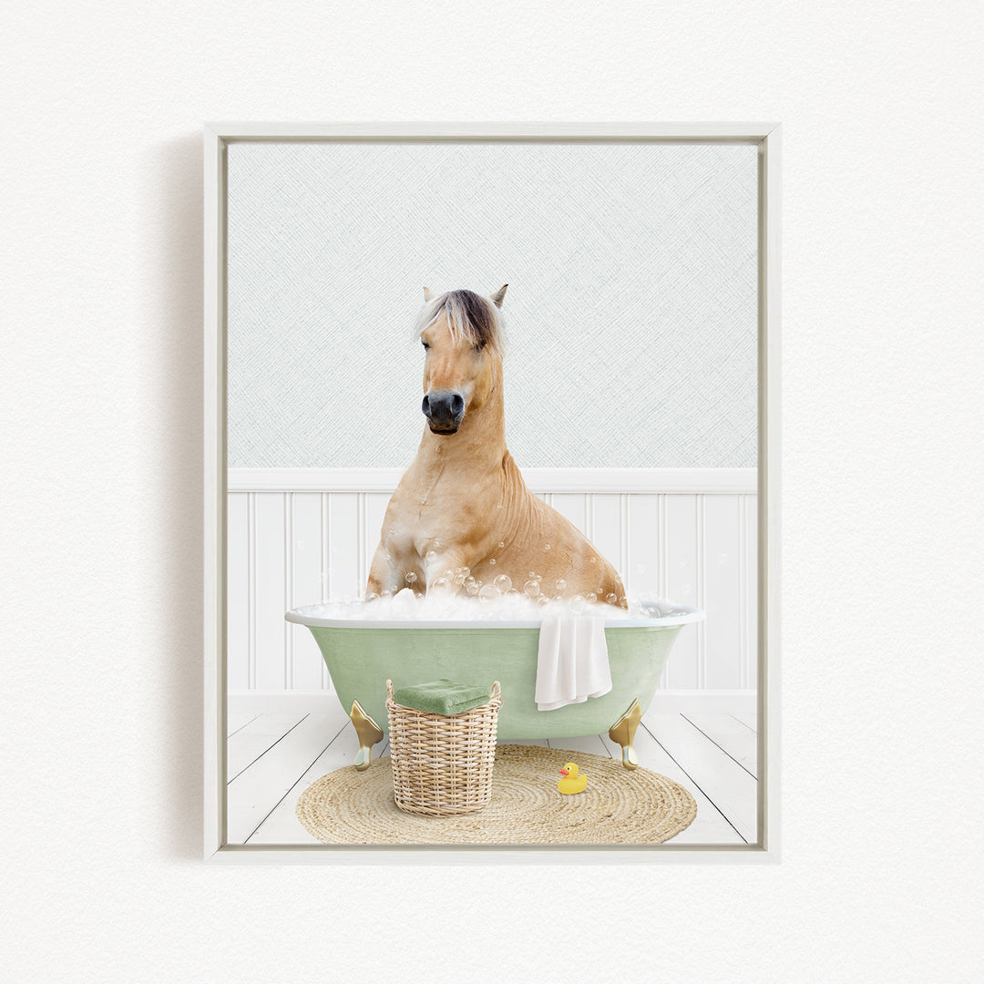 A light brown horse is sitting in a green bathtub filled with water, surrounded by a basket, a yellow rubber duck, and a white towel.