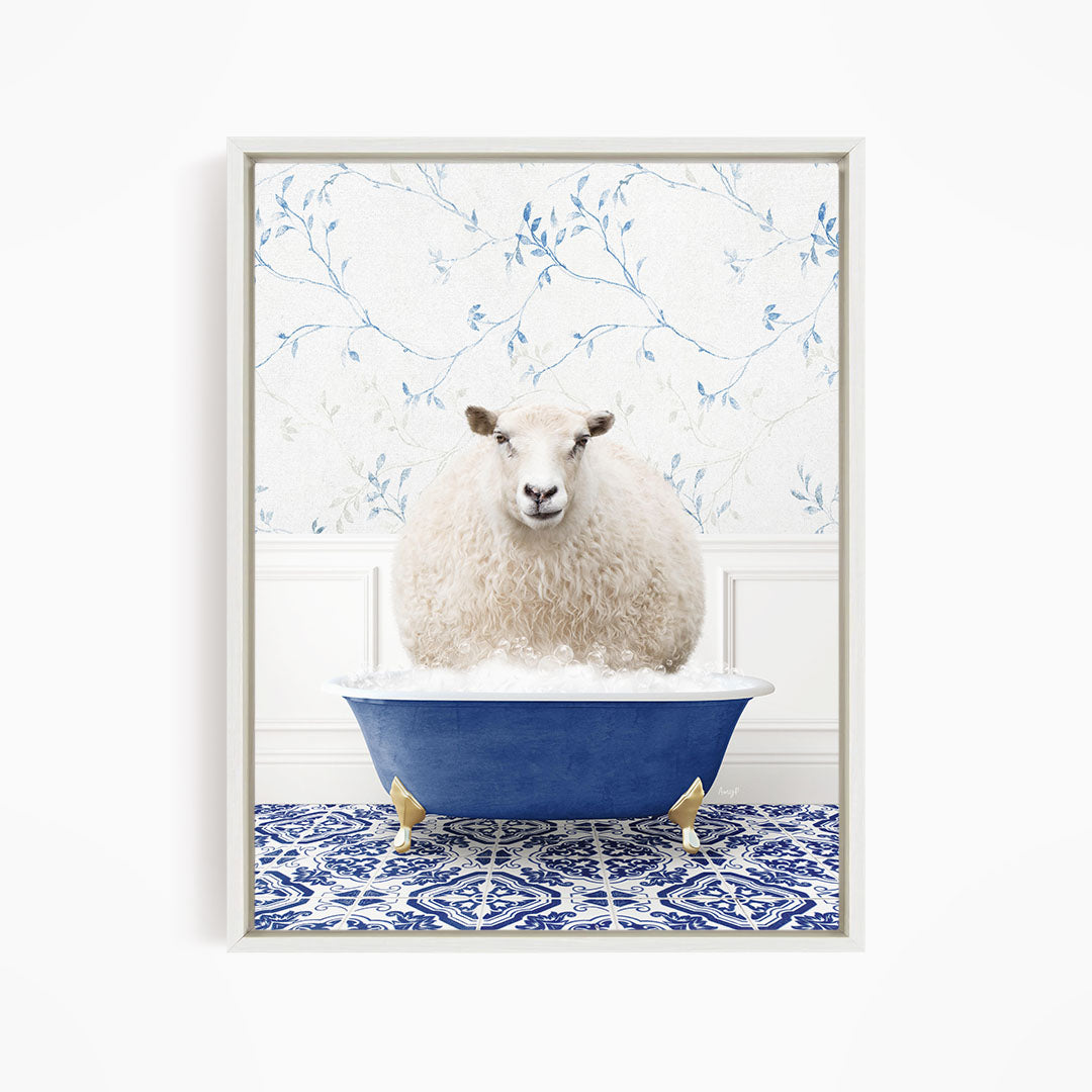 A fluffy white sheep sits in a blue bathtub, surrounded by a blue and white patterned floor.