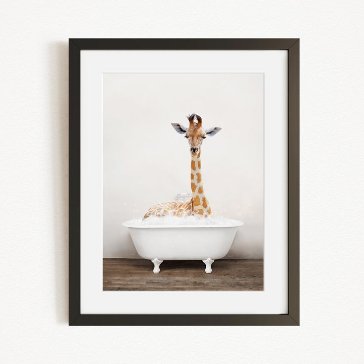 A giraffe sitting in a white bathtub filled with bubbles, creating a whimsical and playful scene.