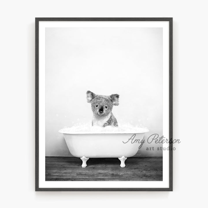 a black and white photo of a koala in a bathtub