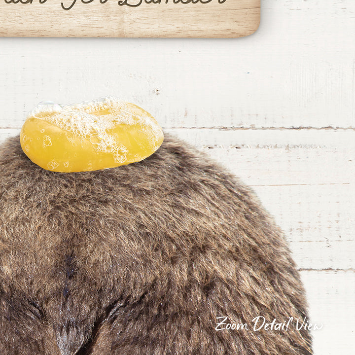 A close-up of a furry animal, possibly a bear or a rabbit, with a yellow object, possibly a soap bubble or a piece of fruit, resting on its head.