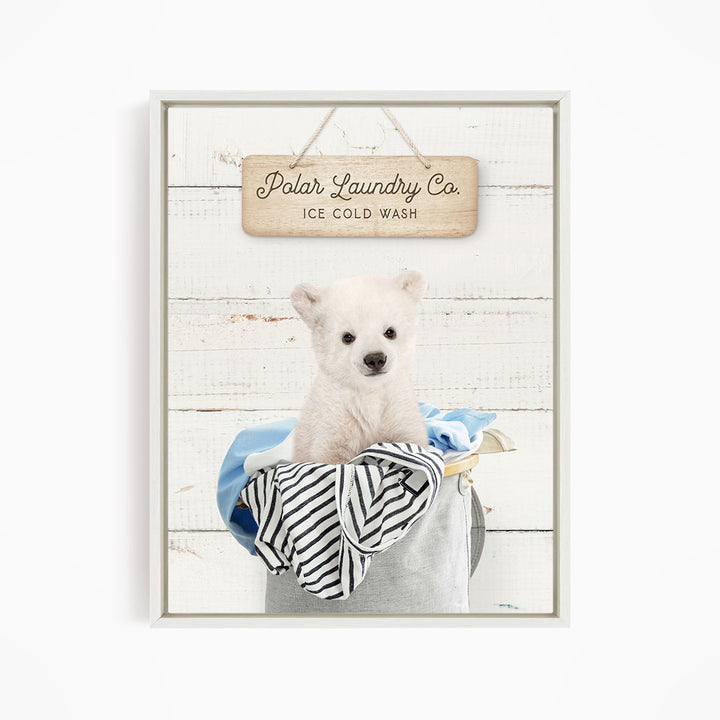A white polar bear sitting in a laundry basket, with a wooden sign above that reads "Polar Laundry Co. Ice Cold Wash".