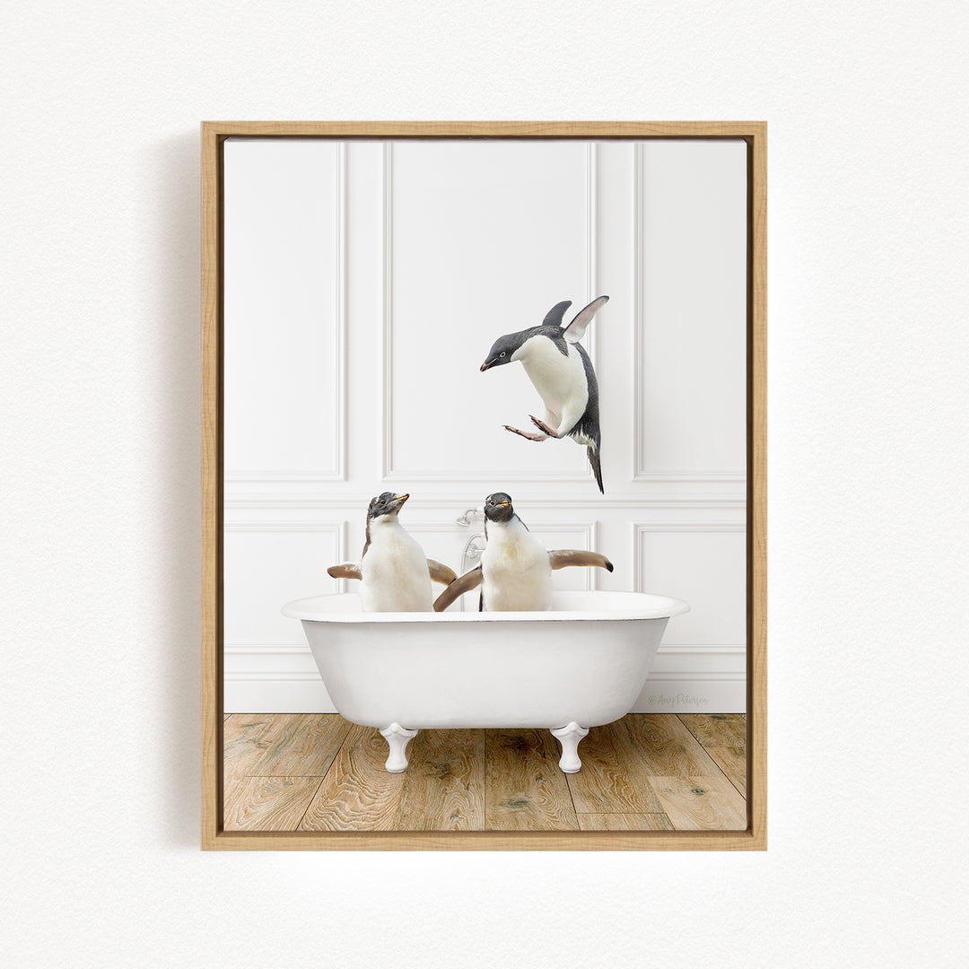 Two penguins sitting in a white bathtub, one of them jumping out of the tub.