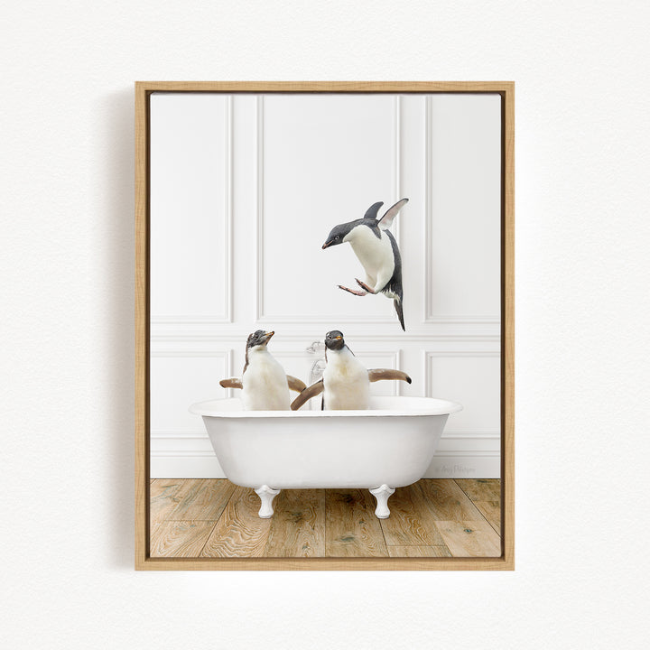 Two penguins sitting in a white bathtub, one of them jumping out of the tub.