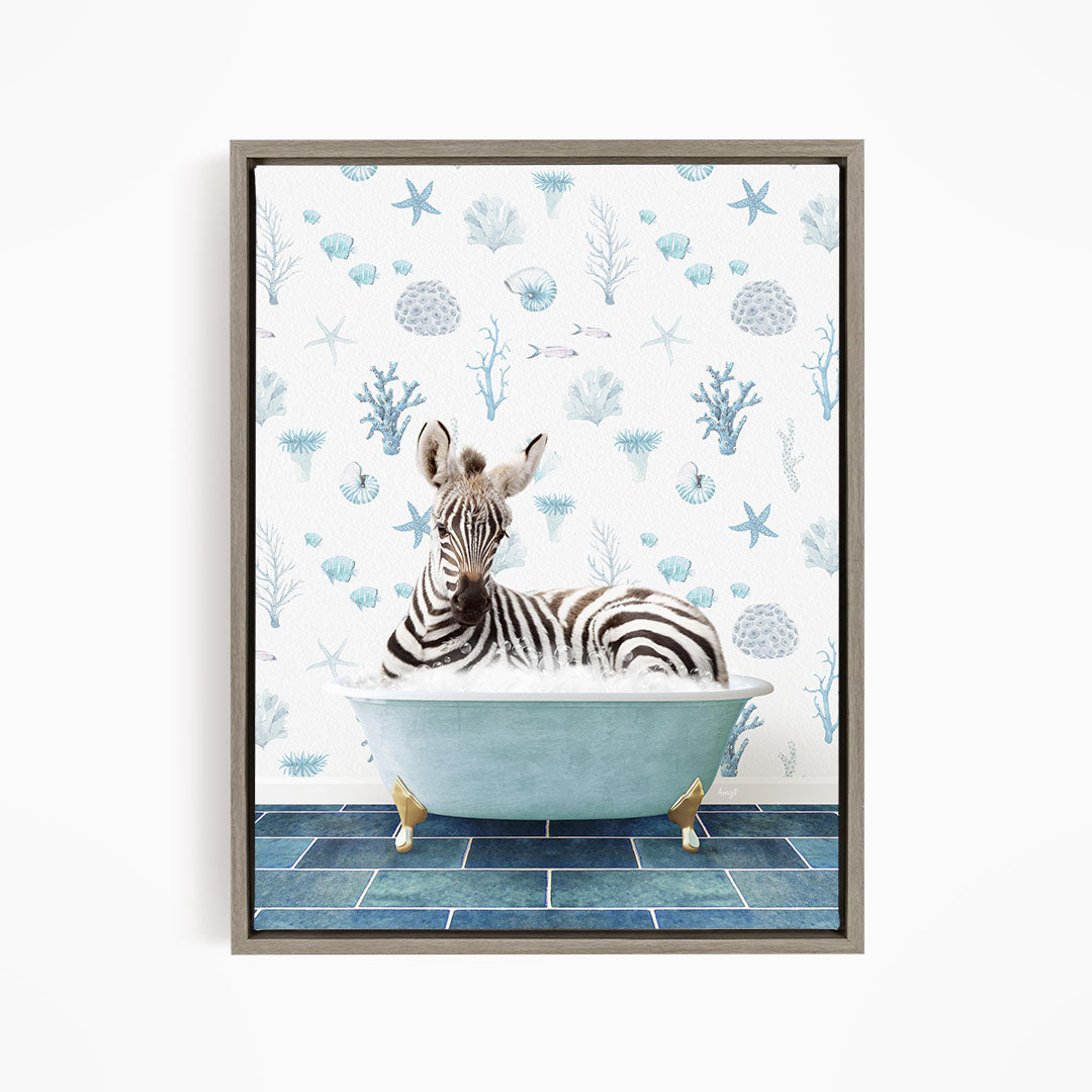 A zebra is sitting in a blue bathtub, surrounded by a pattern of seashells and starfish on the wall behind it.