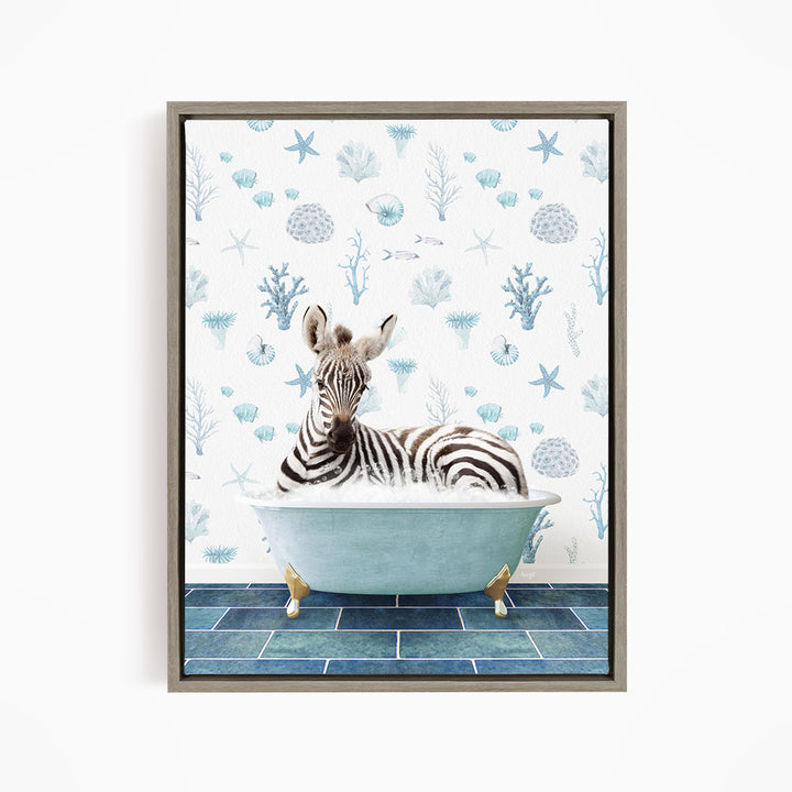A zebra is sitting in a blue bathtub, surrounded by a pattern of seashells and starfish on the wall behind it.