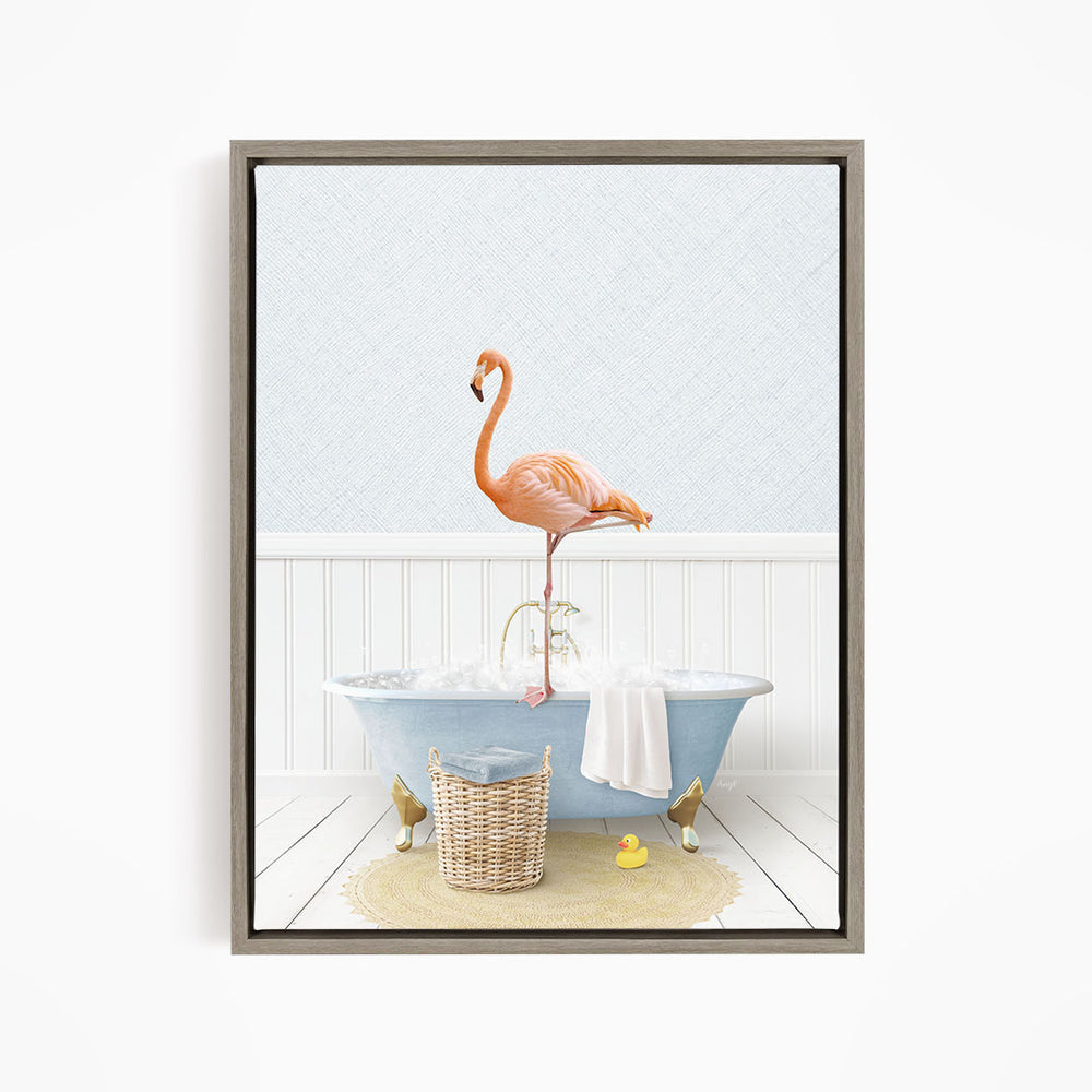 A pink flamingo stands on the edge of a blue bathtub filled with water, surrounded by a basket, a towel, and a yellow rubber duck.