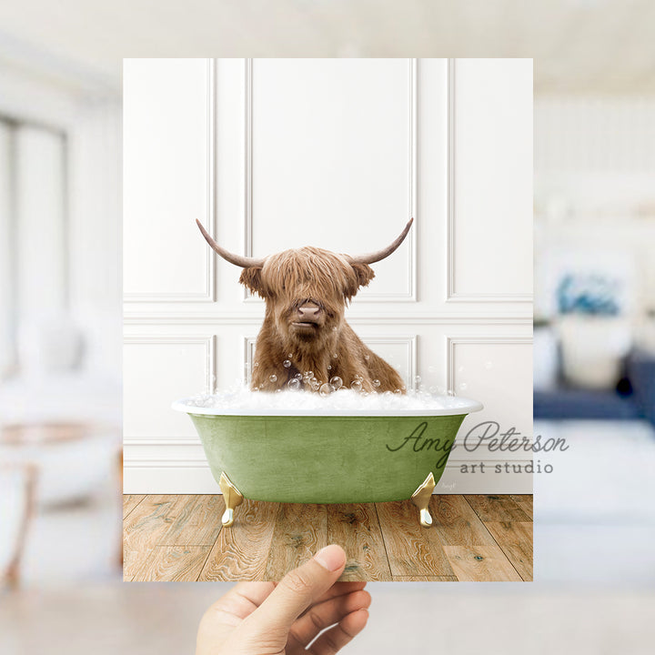 a hand holding a photo of a dog in a bathtub