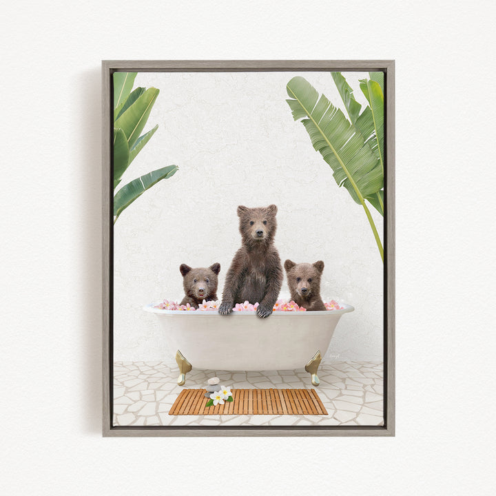 A framed image depicting three bears sitting in a bathtub filled with pink flowers, surrounded by green leaves.