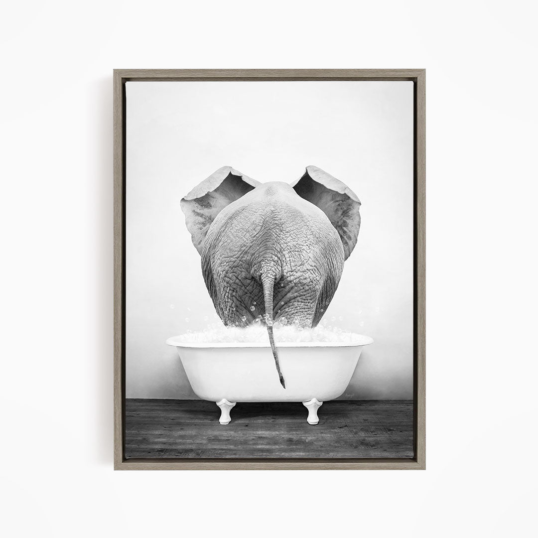 A black and white photograph of an elephant standing in a bathtub filled with water, with its trunk submerged in the water.