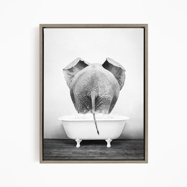 A black and white photograph of an elephant standing in a bathtub filled with water, with its trunk submerged in the water.