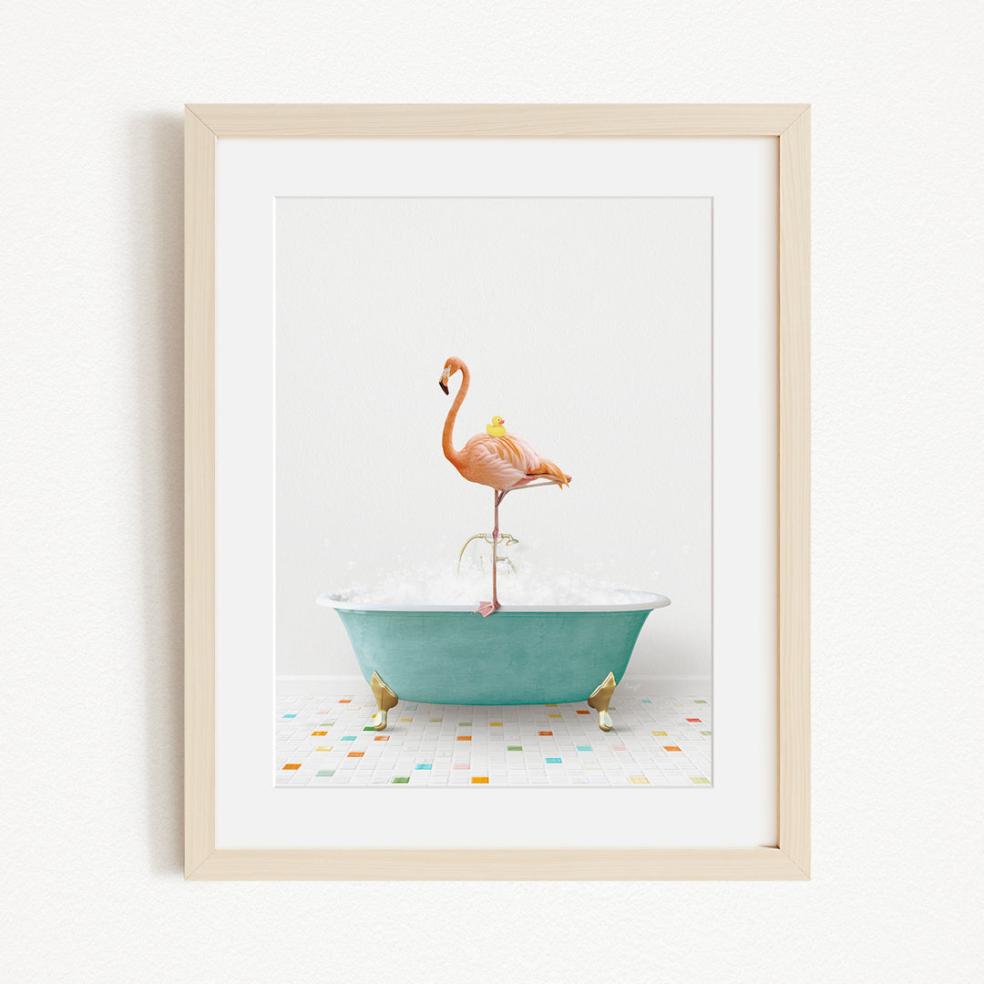 A framed image depicting a pink flamingo standing on a green bathtub filled with water, surrounded by colorful tiles on the floor.