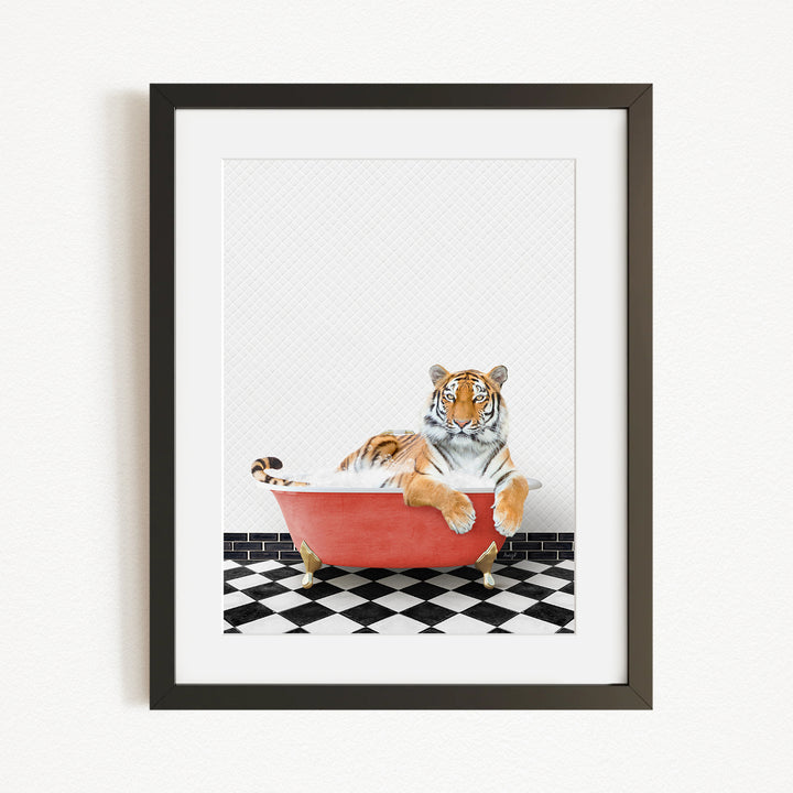 A tiger is sitting in a red bathtub, surrounded by a black and white checkered floor.