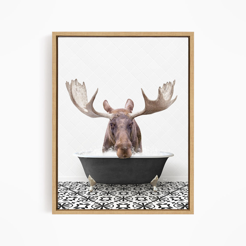 A moose with large antlers is sitting in a bathtub filled with water, creating a whimsical and playful scene.