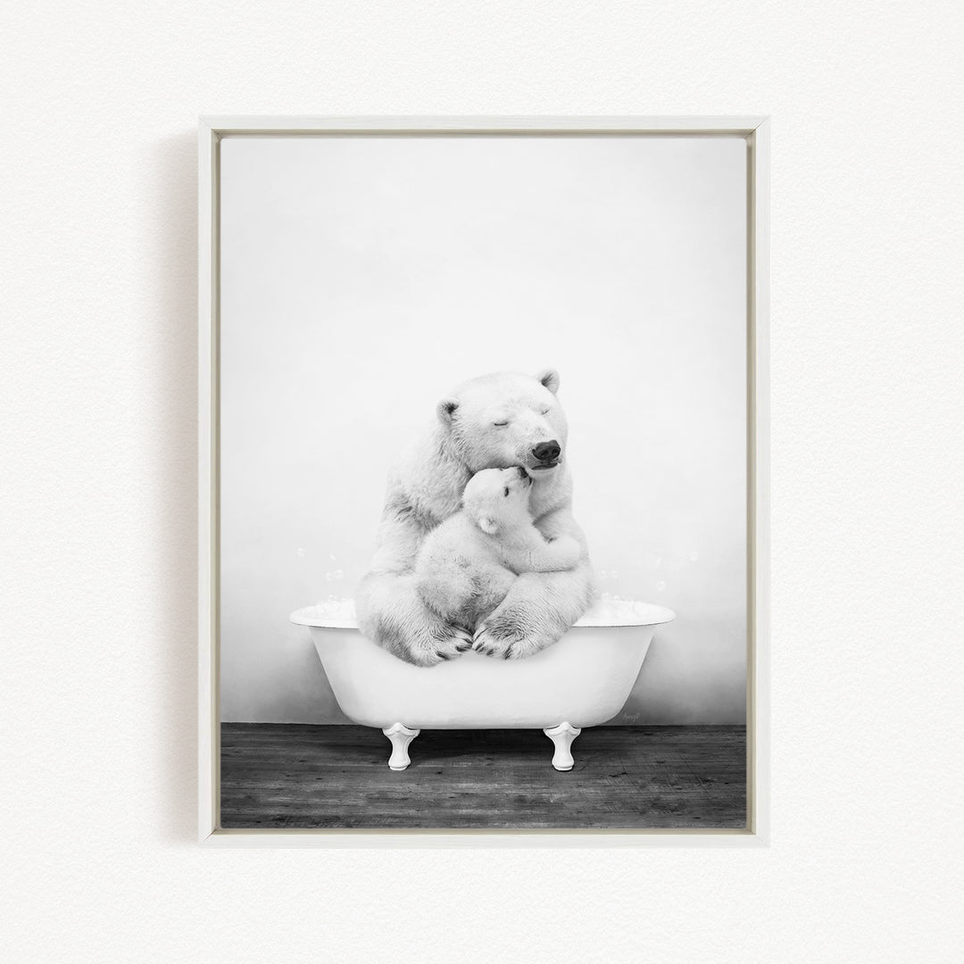 A black and white photograph of a mother polar bear sitting in a bathtub, with her cub nestled close to her.