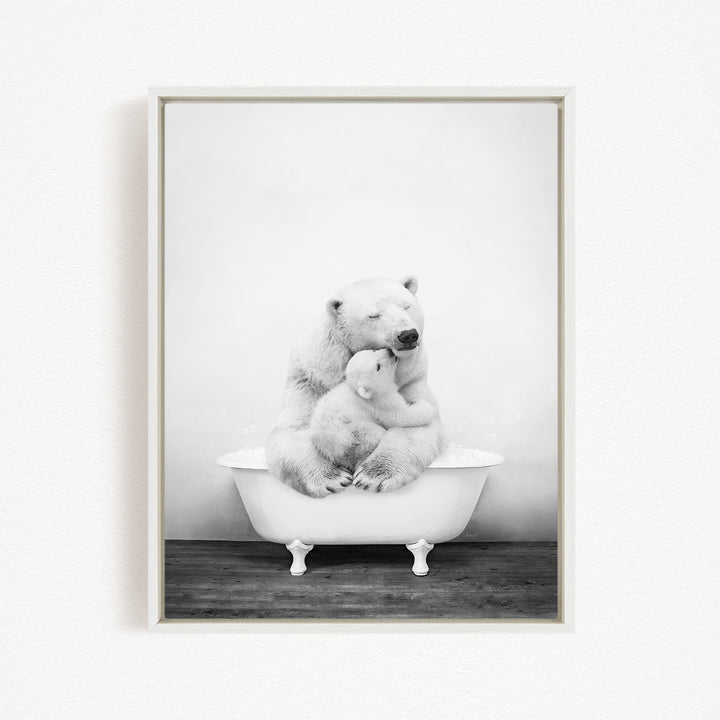 A black and white photograph of a mother polar bear sitting in a bathtub, with her cub nestled close to her.