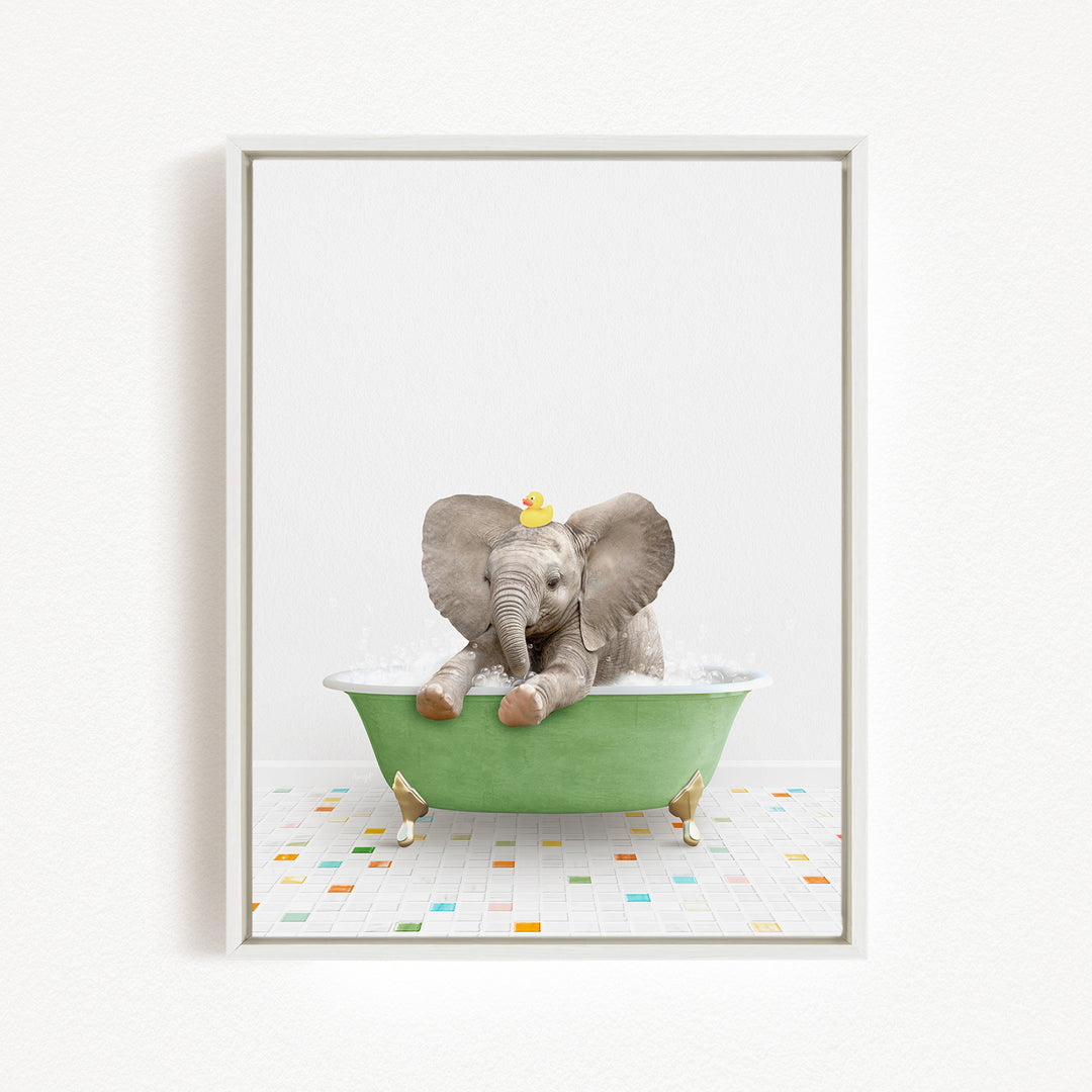 A baby elephant sitting in a green bathtub, with a yellow rubber duck on its head.