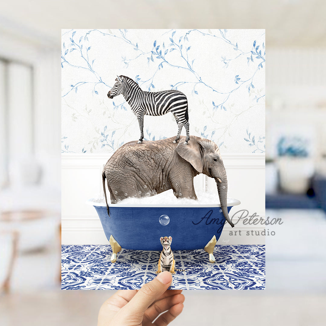 a person holding a card with a picture of an elephant and a zebra on top