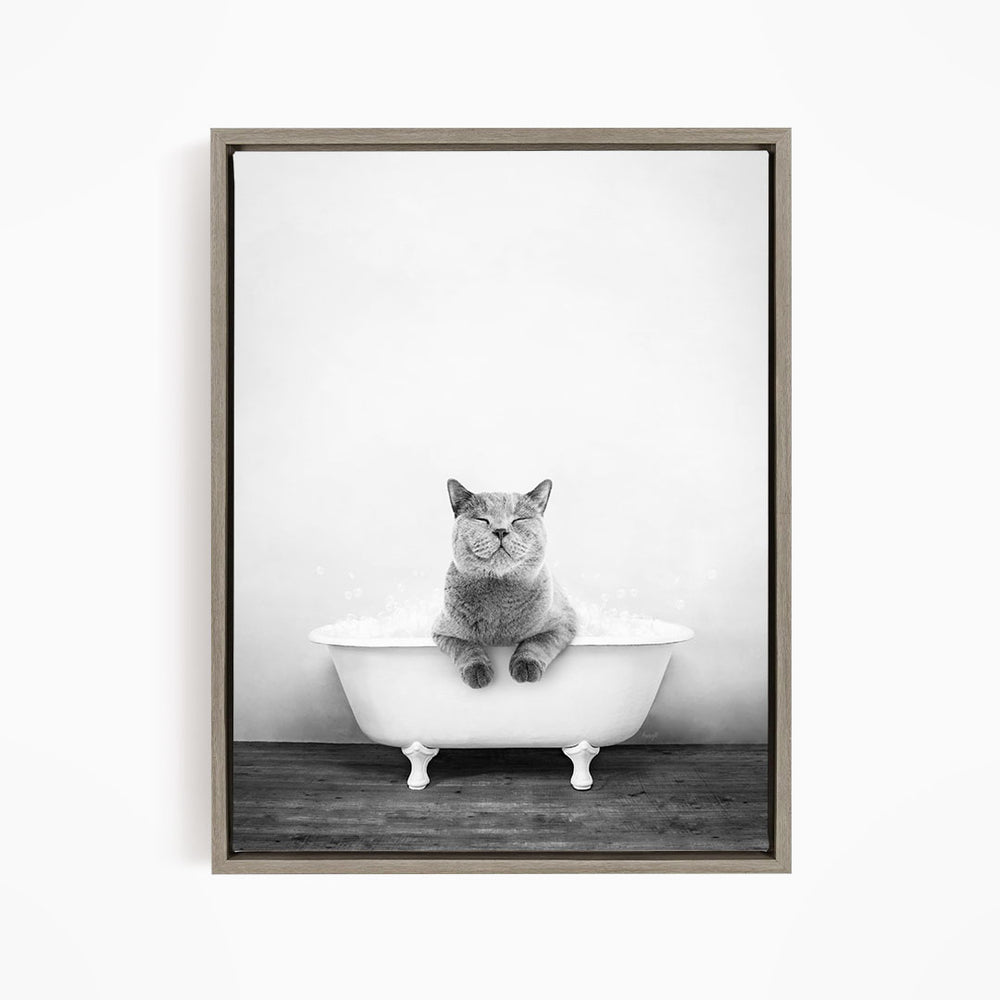 A cat sitting in a bathtub filled with water, appearing to be enjoying the bath.