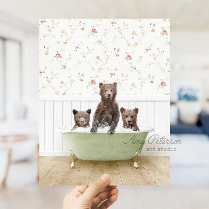 a person holding up a picture of three bears in a bathtub