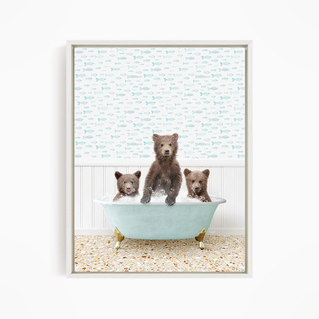 Three brown bears sitting in a light blue bathtub, with a patterned wall behind them.