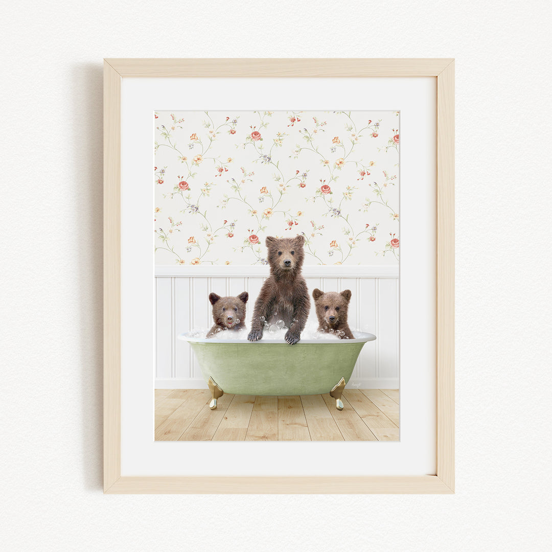 Three adorable brown bears sitting in a green bathtub, with a floral wallpaper in the background.
