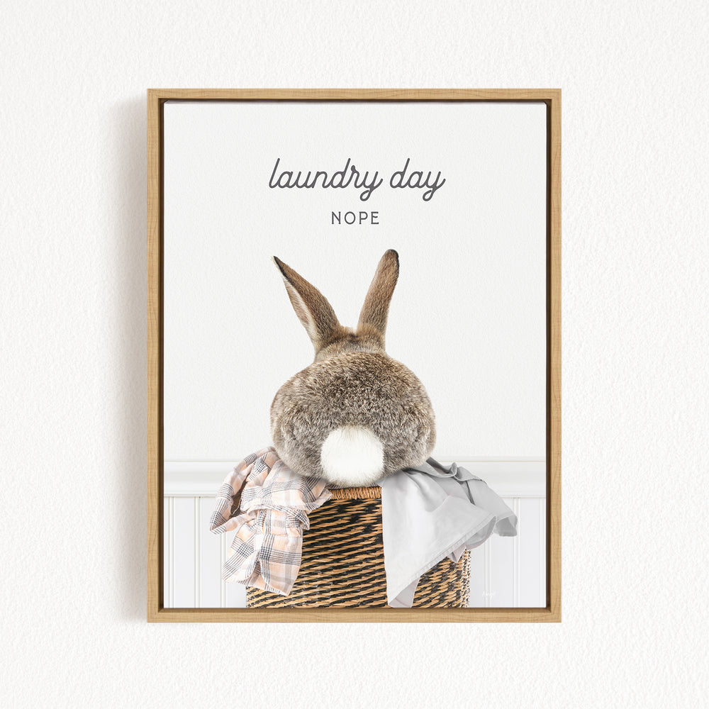 A picture of a rabbit sitting in a basket filled with clothes, with the text "laundry day NOPE" above it.