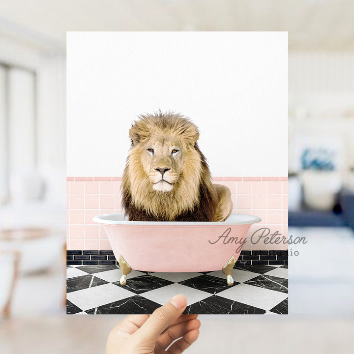 a hand holding a card with a lion in a bathtub