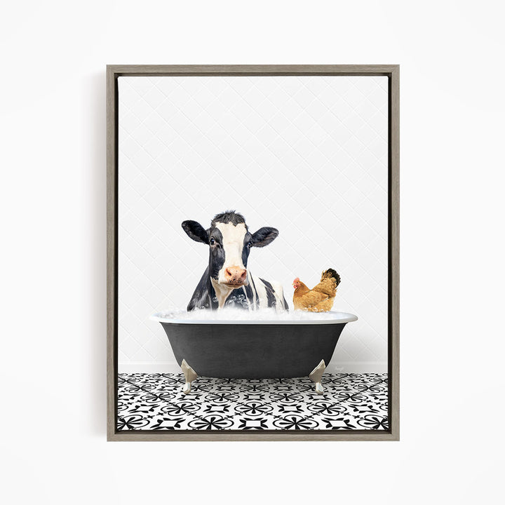A black and white cow is sitting in a bathtub filled with water, with a chicken standing nearby.