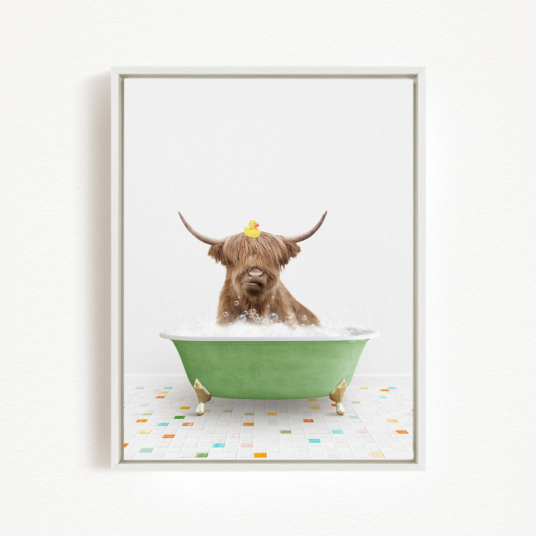 A brown cow with long horns is sitting in a green bathtub filled with bubbles, with a rubber duck perched on its head.