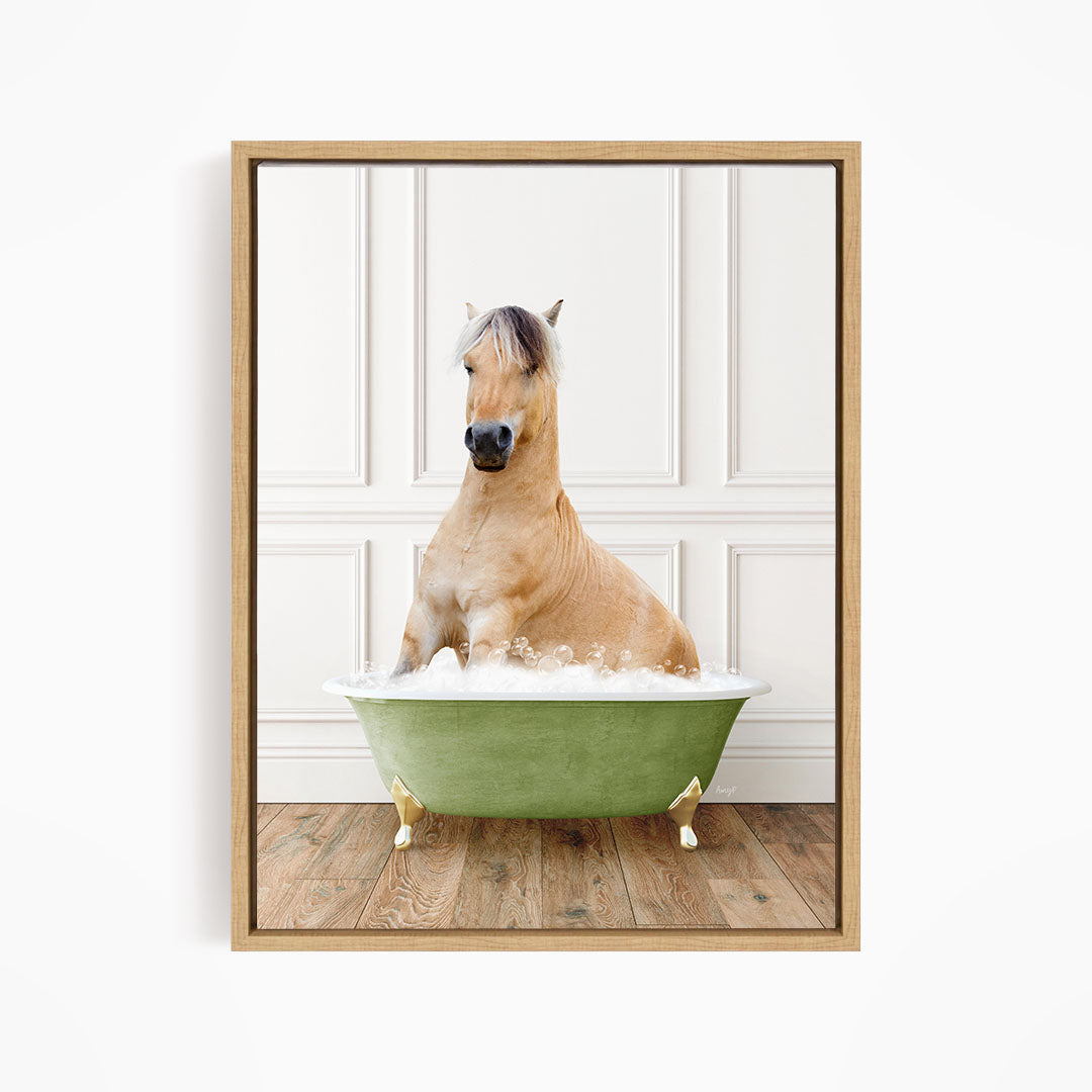 A light brown horse is sitting in a green bathtub filled with water, with its head raised and looking directly at the camera.