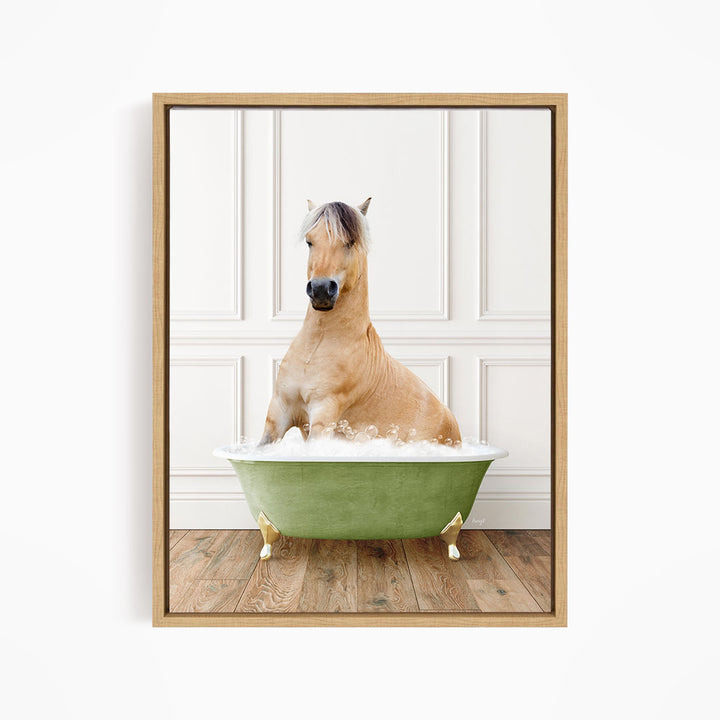 A light brown horse is sitting in a green bathtub filled with water, with its head raised and looking directly at the camera.