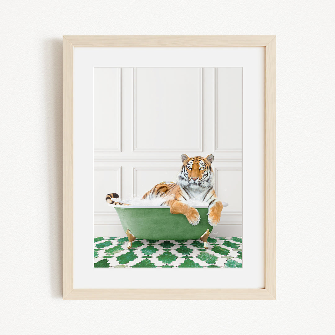 A tiger is sitting in a green bathtub, surrounded by a patterned green and white rug.