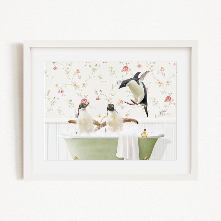 A framed image depicting three penguins enjoying a relaxing bath in a green tub, with a floral wallpaper in the background.