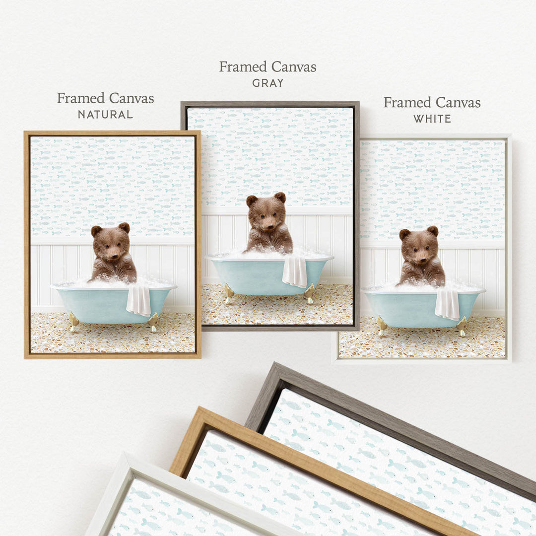 a framed canvas with a brown bear sitting in a blue bathtub, surrounded by a light blue and white patterned background.