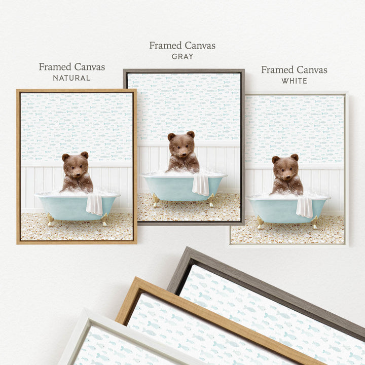 a framed canvas with a brown bear sitting in a blue bathtub, surrounded by a light blue and white patterned background.