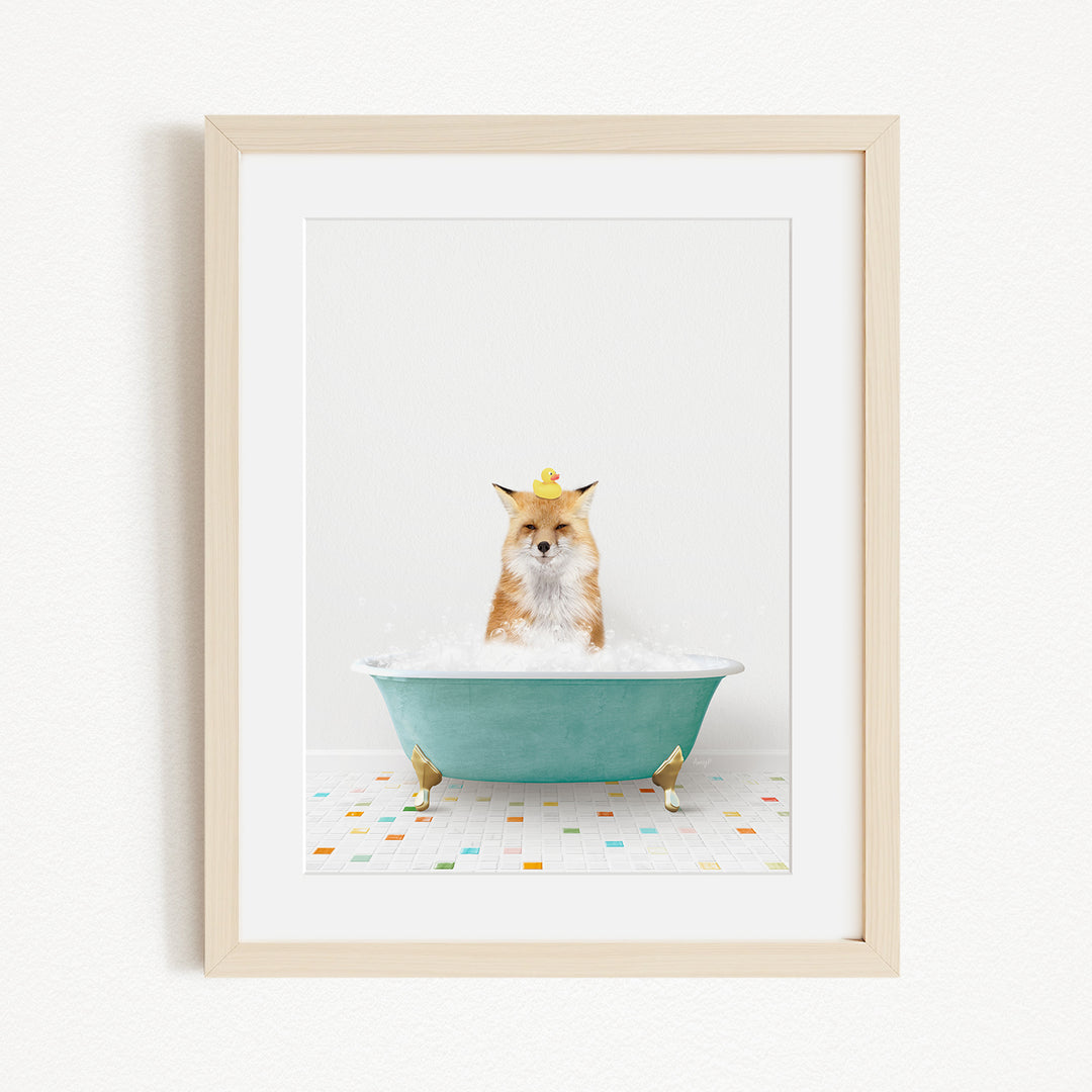 A fox is sitting in a green bathtub filled with bubbles, with a yellow rubber duck perched on its head.