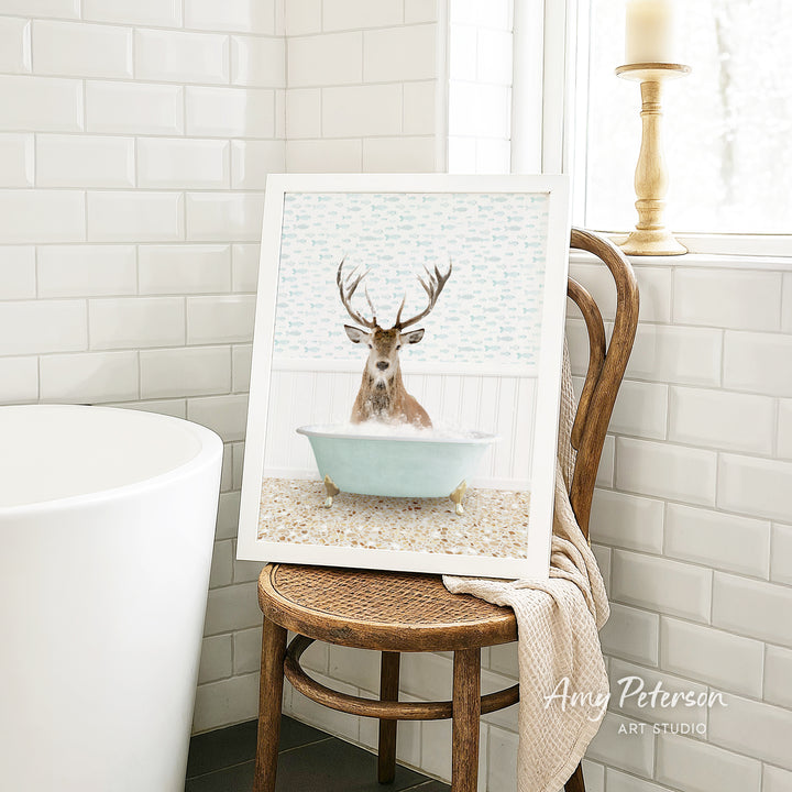 A framed image of a deer sitting in a bathtub, surrounded by a tiled bathroom setting.