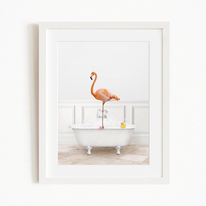 A pink flamingo stands on the edge of a white bathtub filled with water, with a yellow rubber duck floating in the water.