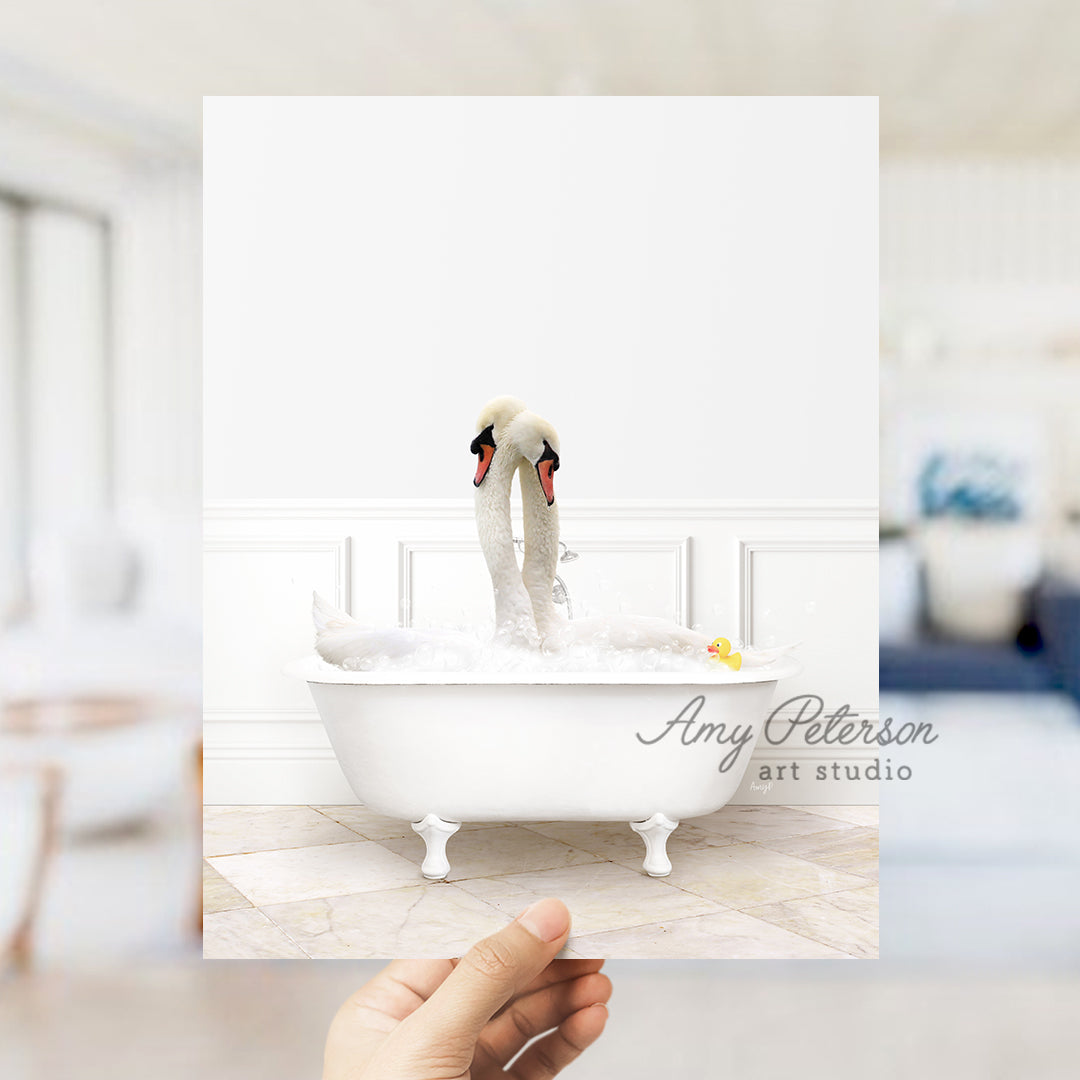 a person holding up a picture of a swan in a bathtub