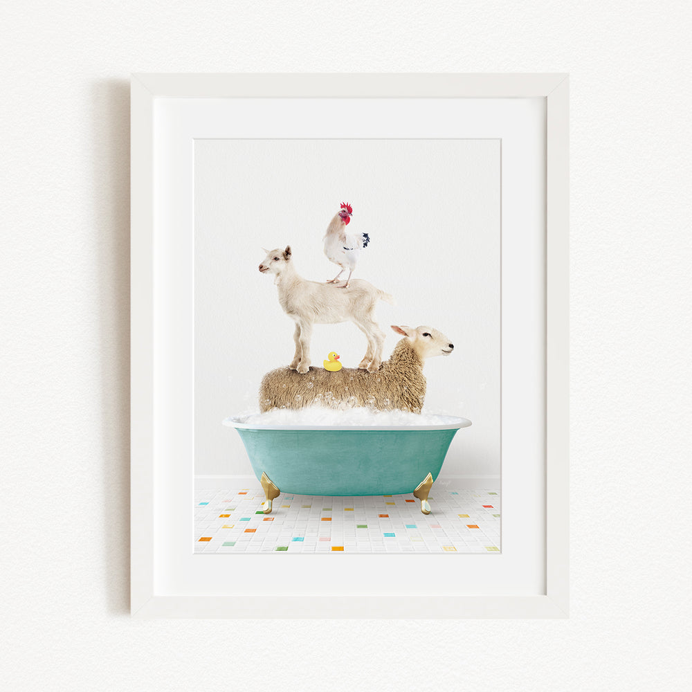 A framed image depicting a sheep standing on a tub filled with bubbles, with a chicken perched on top and a duck sitting on the sheep's back.