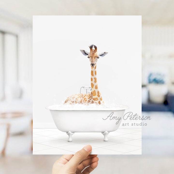 a hand holding up a card with a giraffe in a bathtub